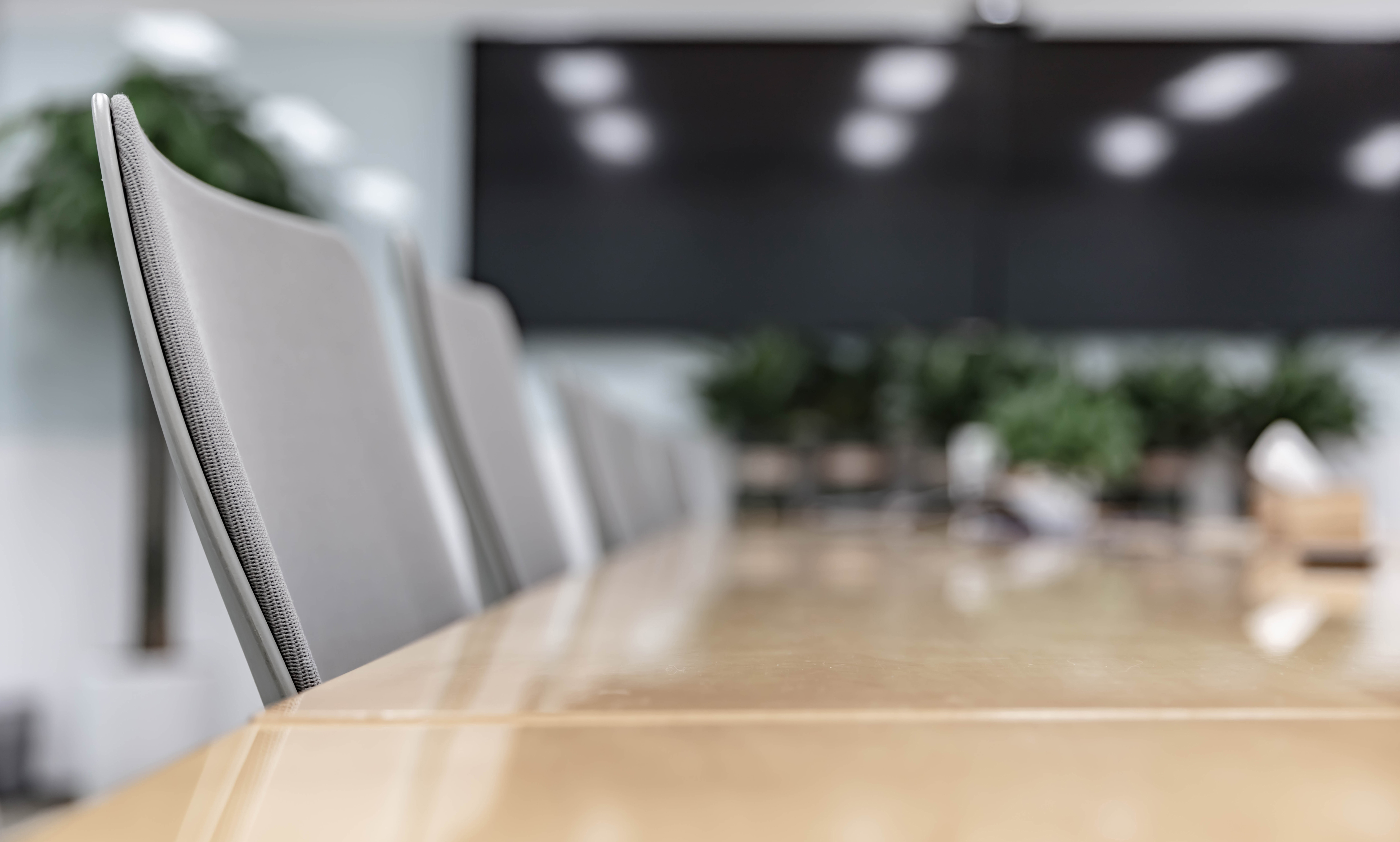 Close up on chairs at a conference table